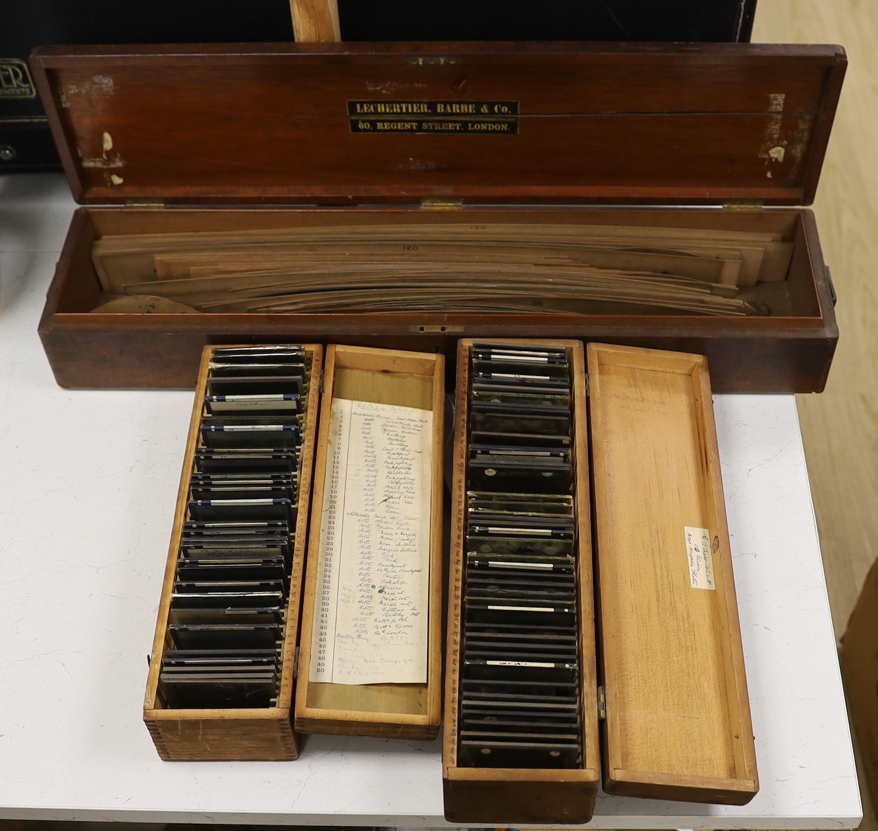 Two boxed sets of photographic magic lantern slides including military and a mahogany cased collection of wood radii templates stamped Hudelo, Paris, longest box 73cm